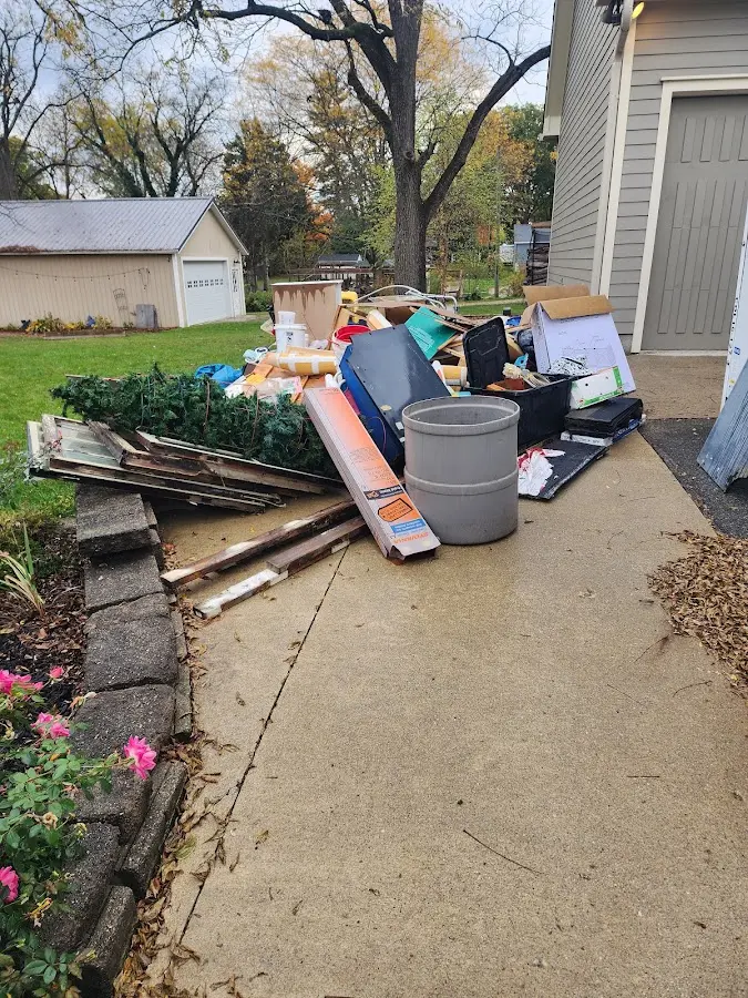 Dumpster being loaded with debris for Estate Cleanout Dumpster Rental in Pierson